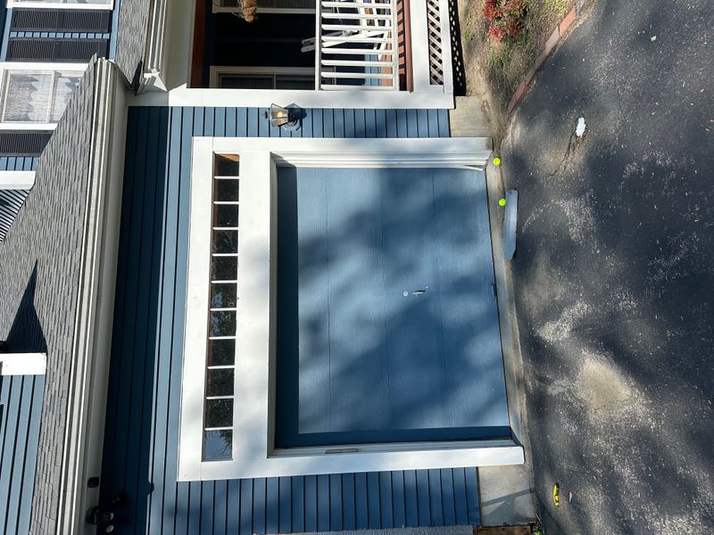 Modern blue flush garage door with side window column on blue colonial — Massachusetts